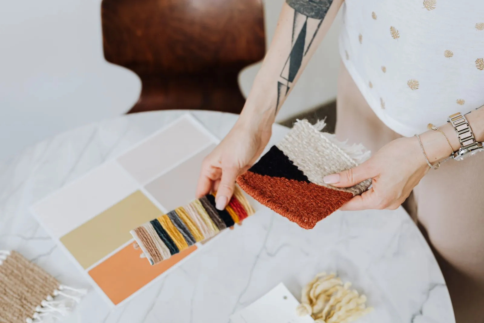 Designer comparing fabric and finish samples
