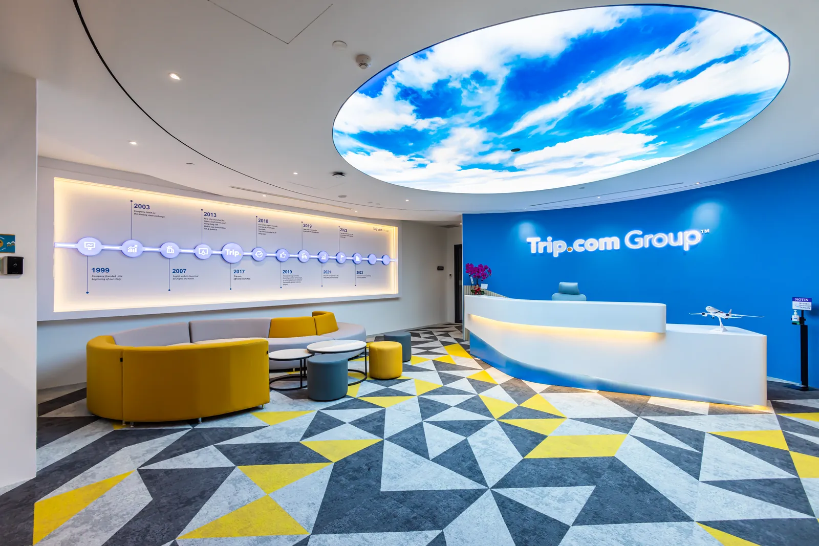 Reception with a sky-light ceiling feature, curved counter and lounge seating