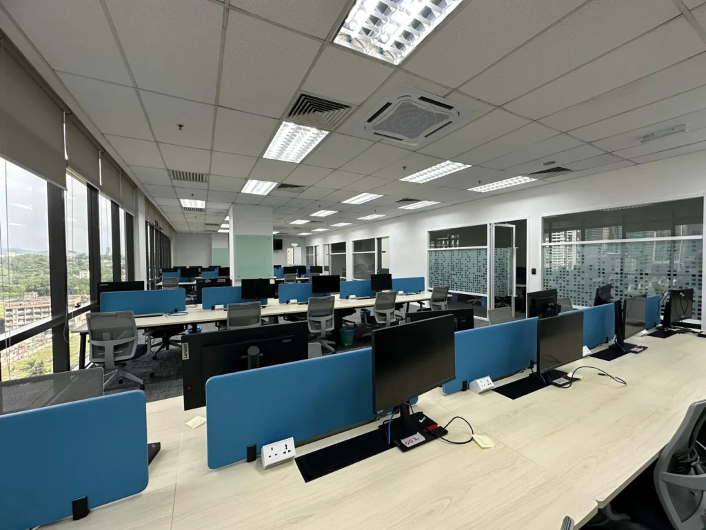 Open-plan office workstations by the window