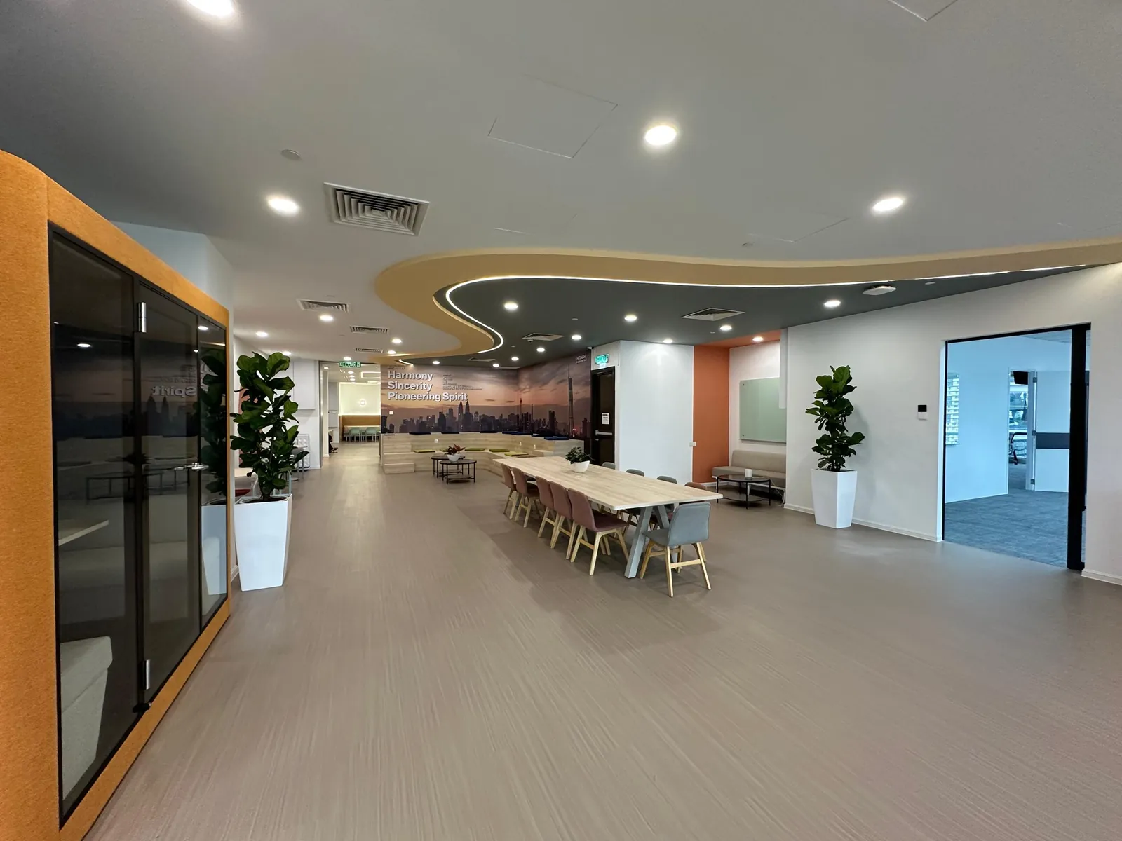 Breakout area with soft seating beside the workstations
